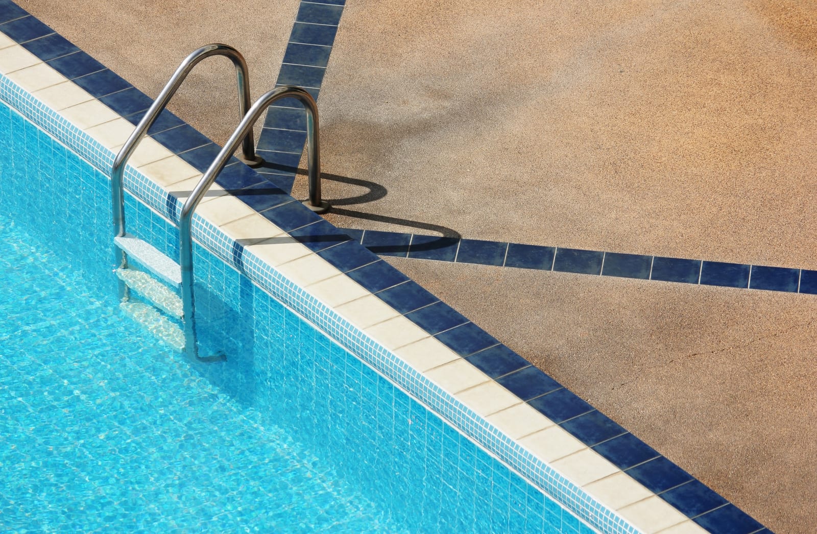 Inground swimming pool with wide stone entry steps at a residential property