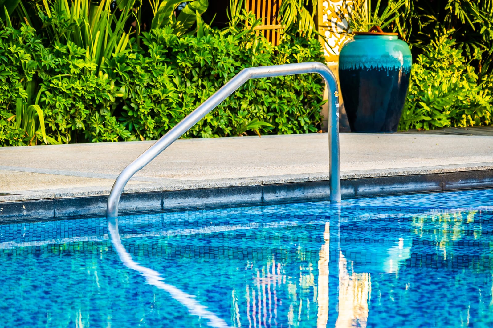 Outdoor pool deck with lounge chairs and a shade umbrella
