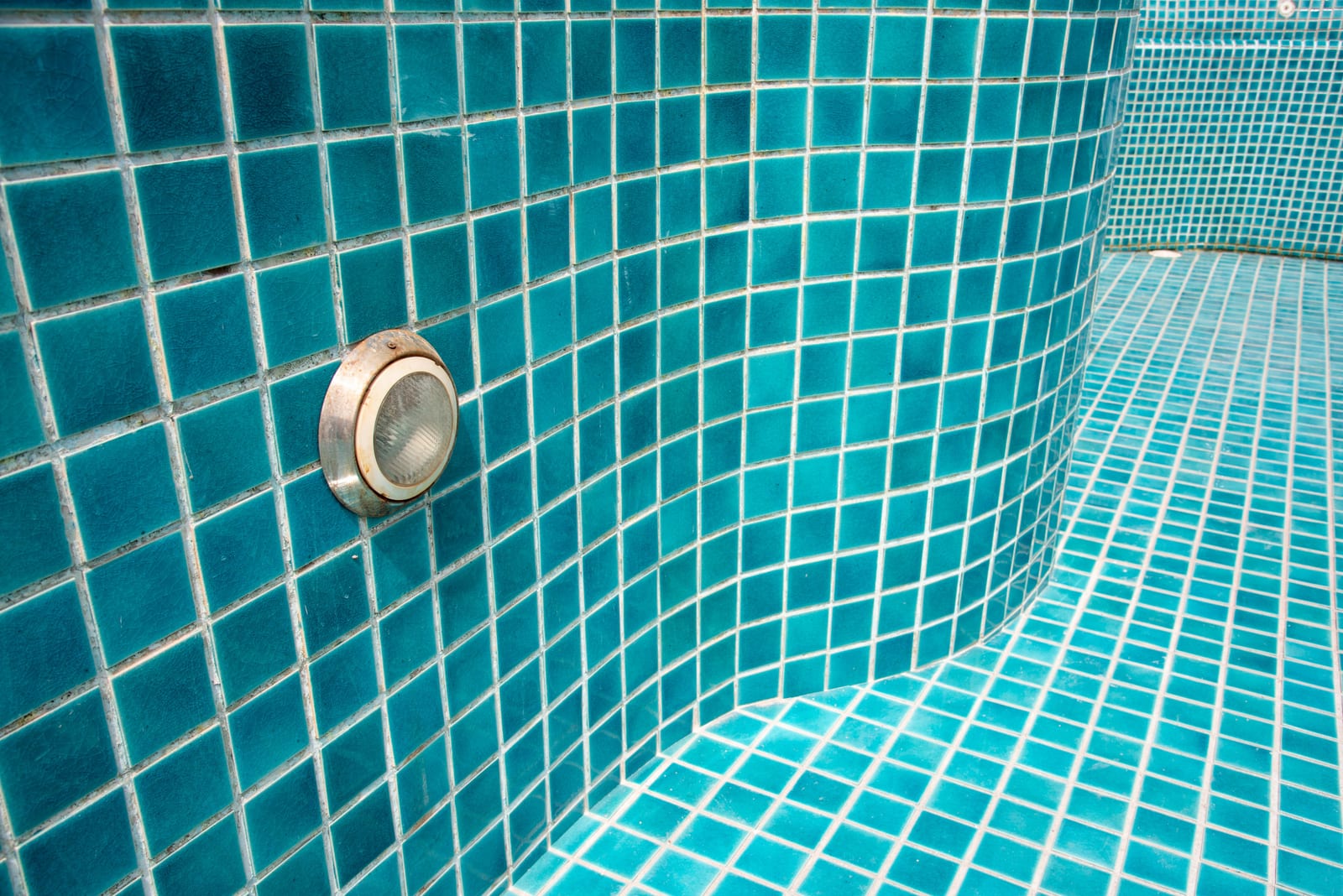 Close-up of fresh blue pool tile during a construction phase