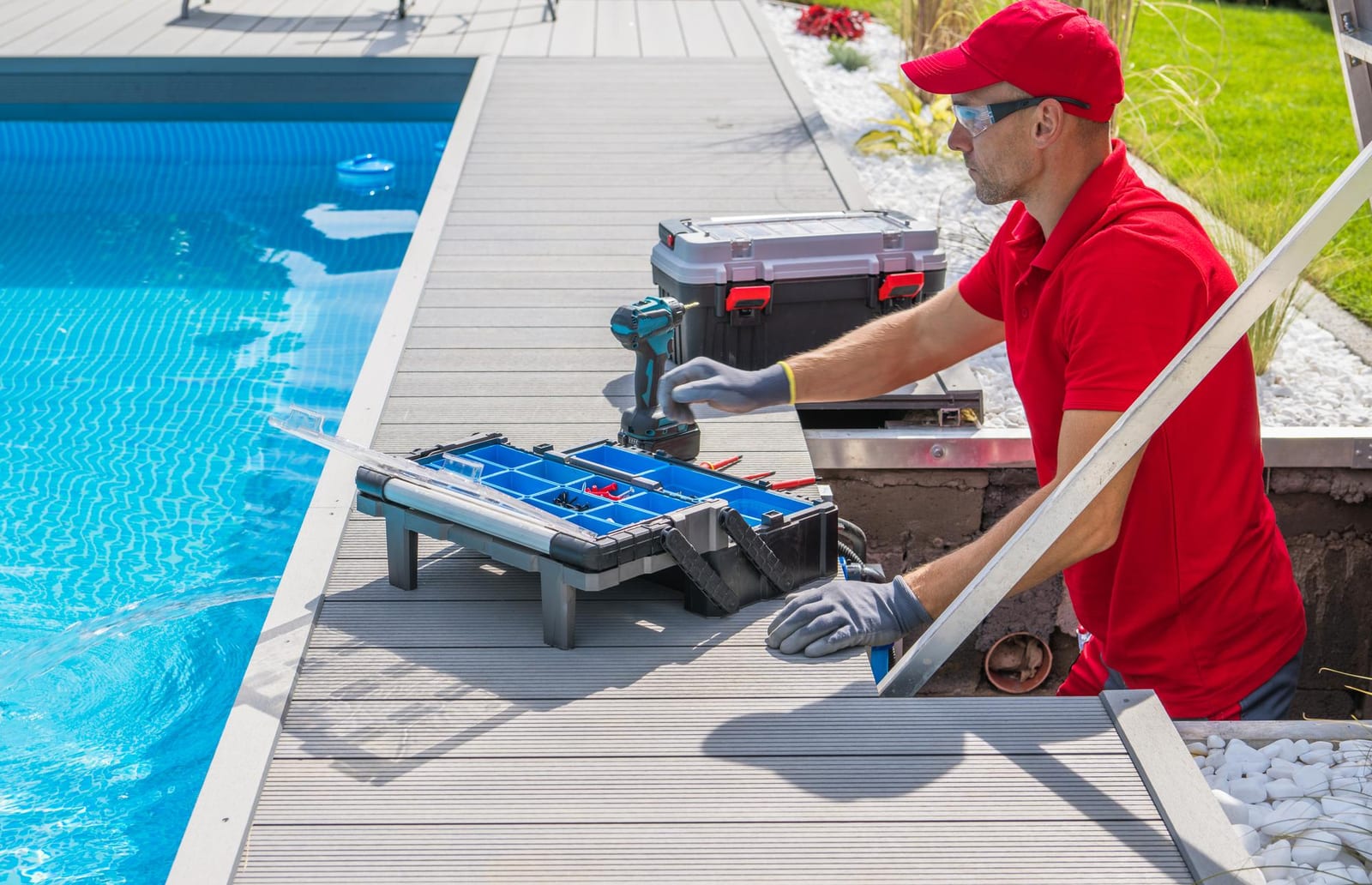 Technician performing outdoor pool maintenance service