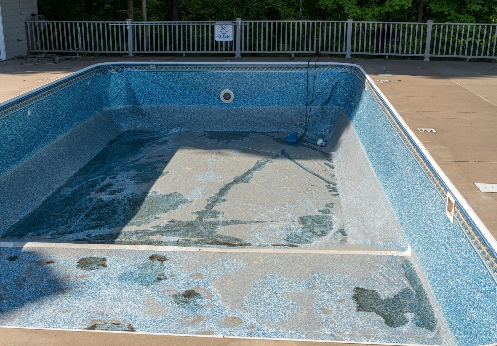 Empty inground pool shell prepared for new vinyl liner installation