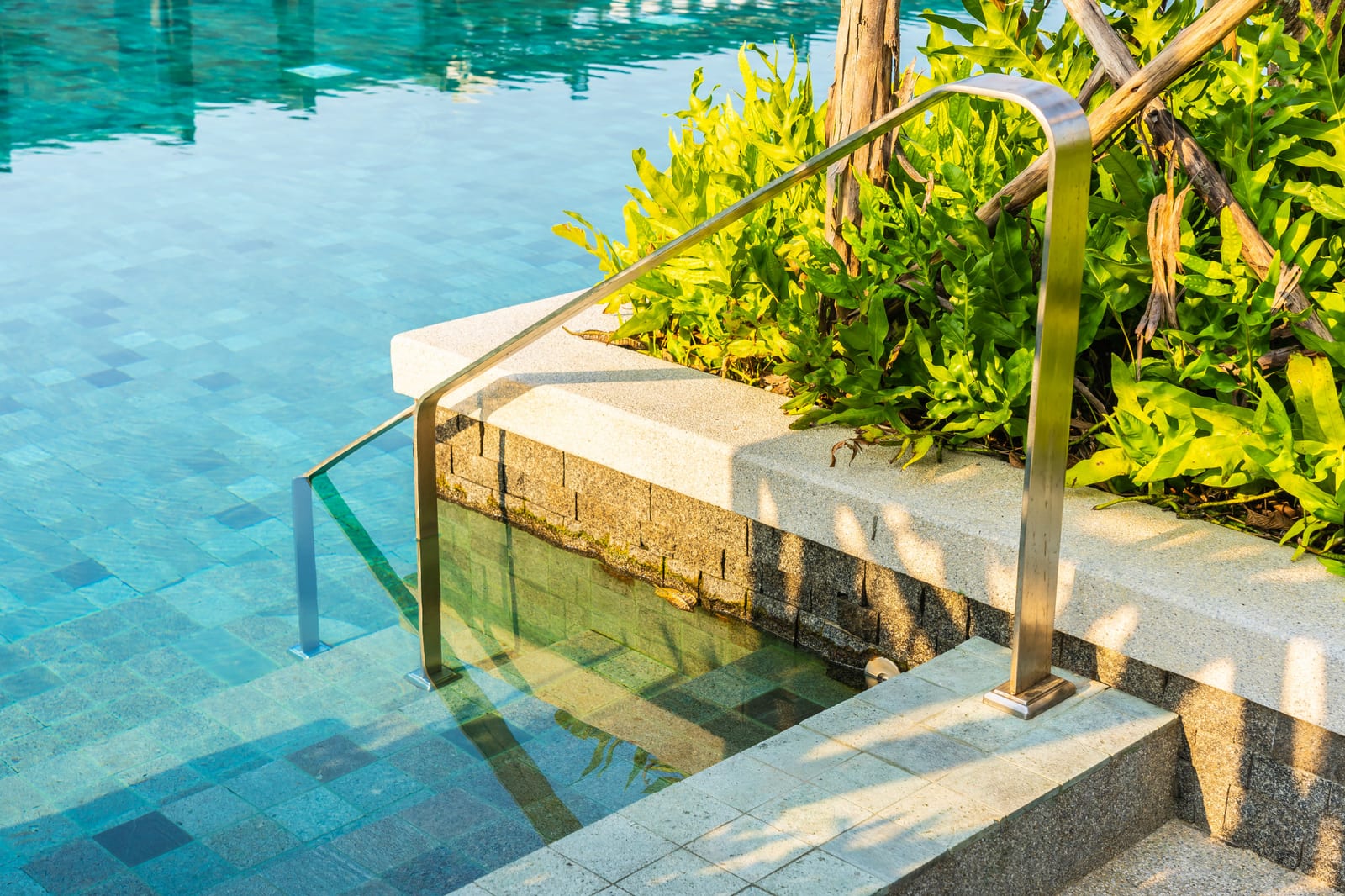 Outdoor pool with a stair ladder along the deck edge